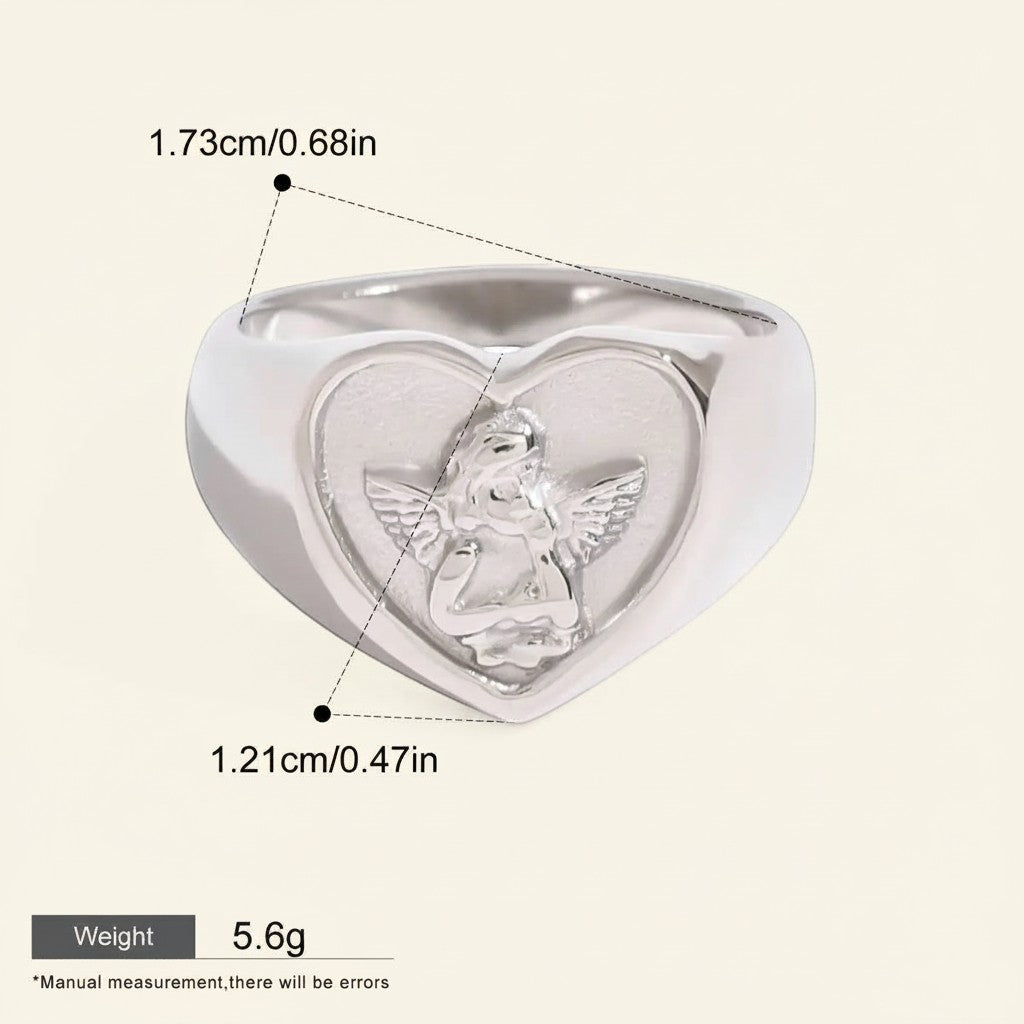 Seraphina Treasures Aetheris ring with a heart-shaped face featuring an angel motif. Silver-tone metal.