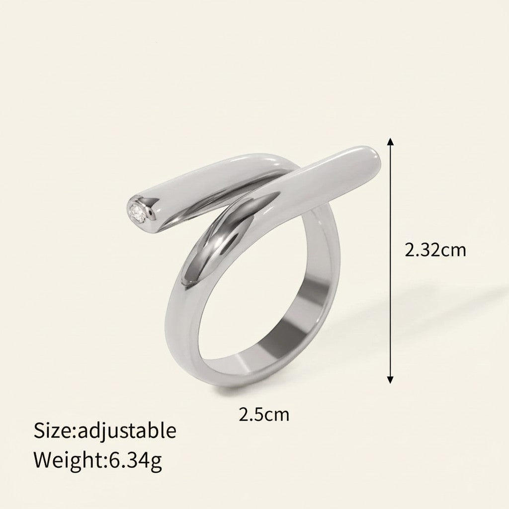 Seraphina Treasures Ariadne ring with a unique modern shape and sparkling zirconia edge. Silver-tone metal.