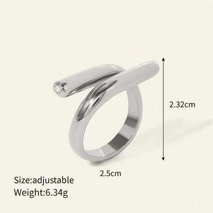 Seraphina Treasures Ariadne ring with a unique modern shape and sparkling zirconia edge. Silver-tone metal.
