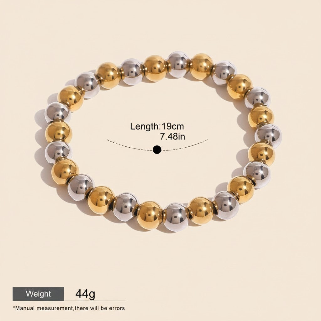 Seraphina Treasures Clio bracelet with alternating gold and silver stainless steel beads. Elastic design for a comfortable fit.