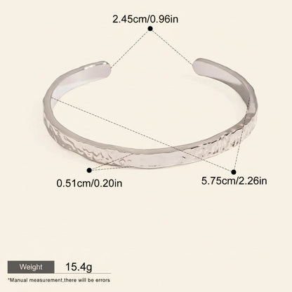 Seraphina Treasures Cyrine silver-tone metal open bangle with hammered texture. Waterproof and hypoallergenic.