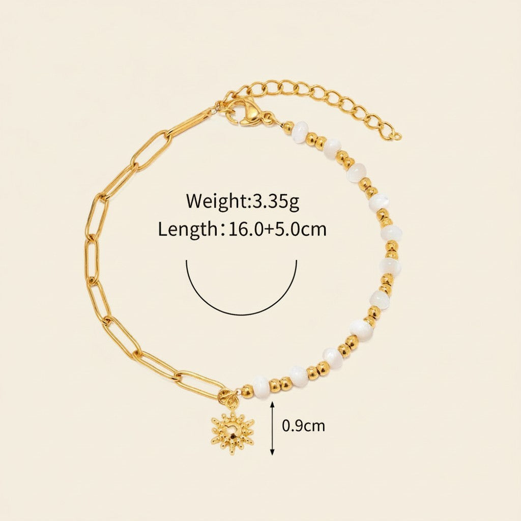 Seraphina Treasures Delia bracelet with gold chain, white shell beads, and a sun charm.