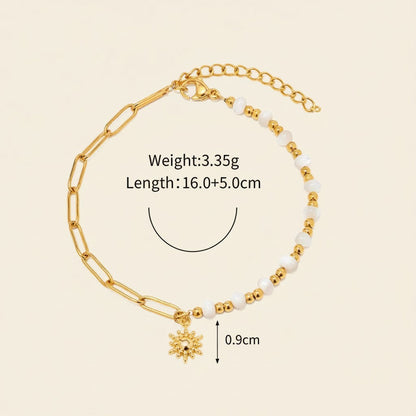 Seraphina Treasures Delia bracelet with gold chain, white shell beads, and a sun charm.