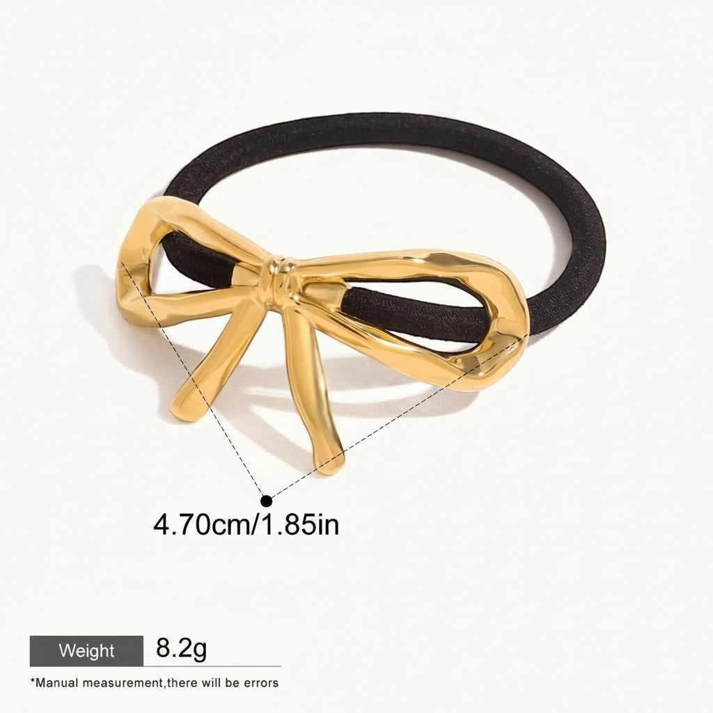 Seraphina Treasures gold metal bow hair tie accessory on black elastic band.
