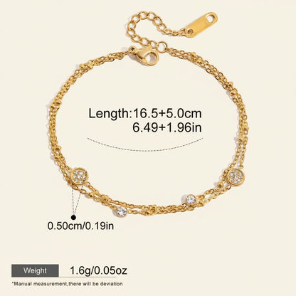 Seraphina Treasures gold-tone two-tier bracelet with beaded chains and clear crystal charms. Adjustable length.