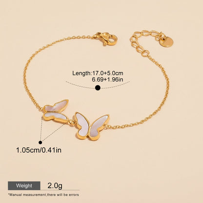Seraphina Treasures gold-tone bracelet with white shell butterfly charms. Adjustable chain.