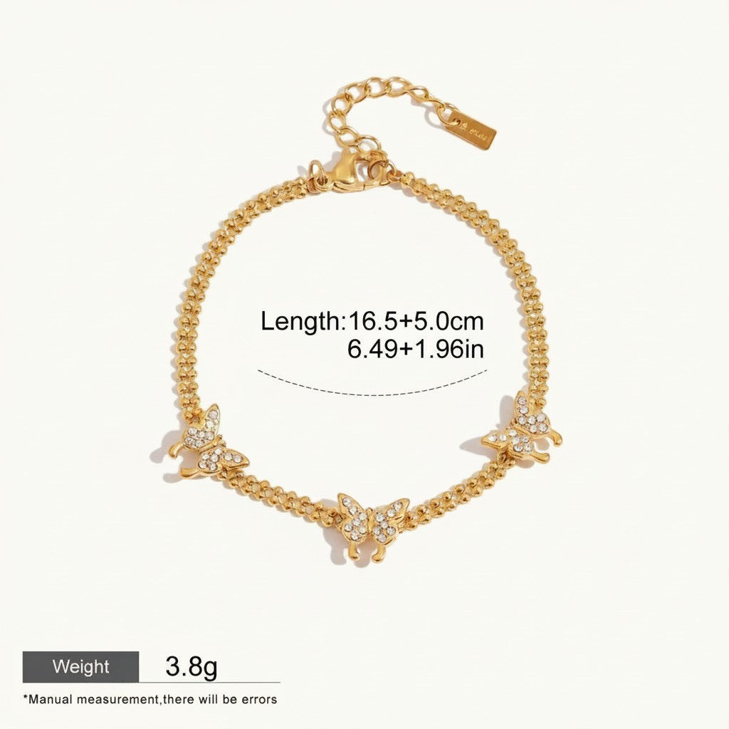 Seraphina Treasures gold-tone bracelet with cubic zirconia butterfly charms. Adjustable chain.