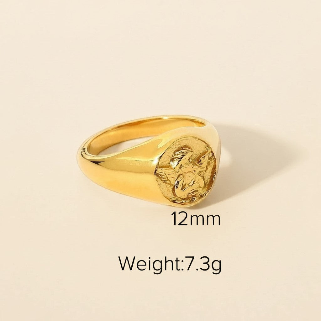 Seraphina Treasures gold cherub signet ring with 12mm width and 7.3g weight.