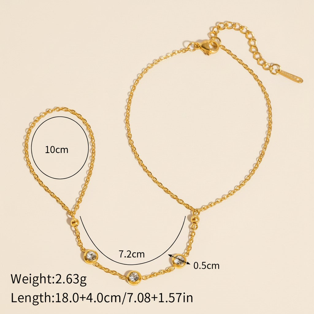 Seraphina Treasures gold-tone connected bracelet and ring set with cubic zirconia stones.