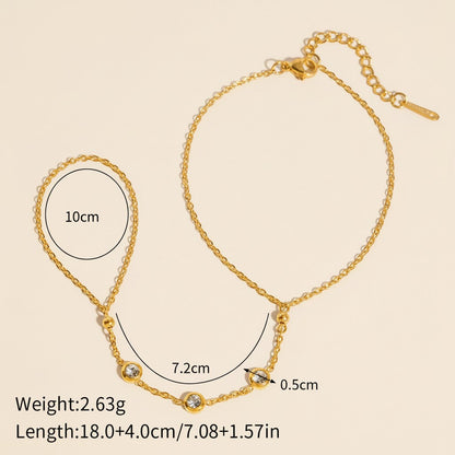 Seraphina Treasures gold-tone connected bracelet and ring set with cubic zirconia stones.
