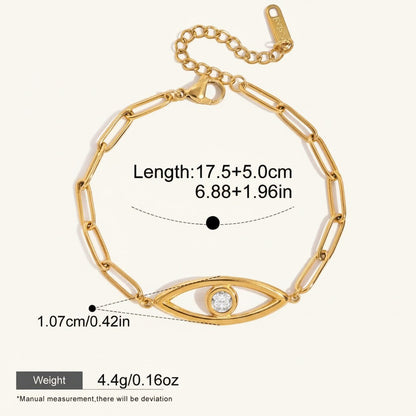 Seraphina Treasures gold-tone stainless steel bracelet with paperclip chain and a central evil eye charm featuring a clear zircon.