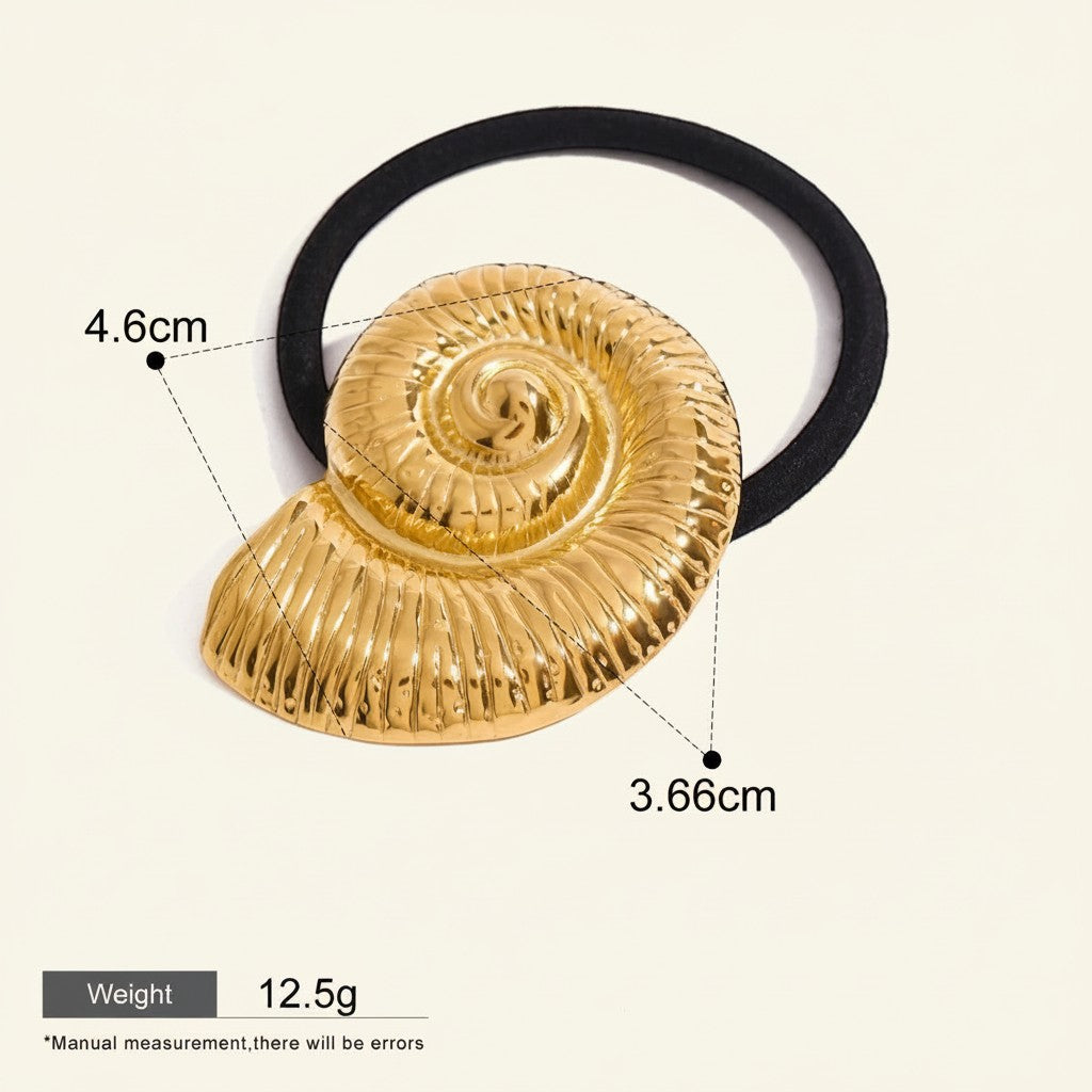 Seraphina Treasures gold ammonite fossil hair tie with black elastic band. Unique ocean-inspired accessory.