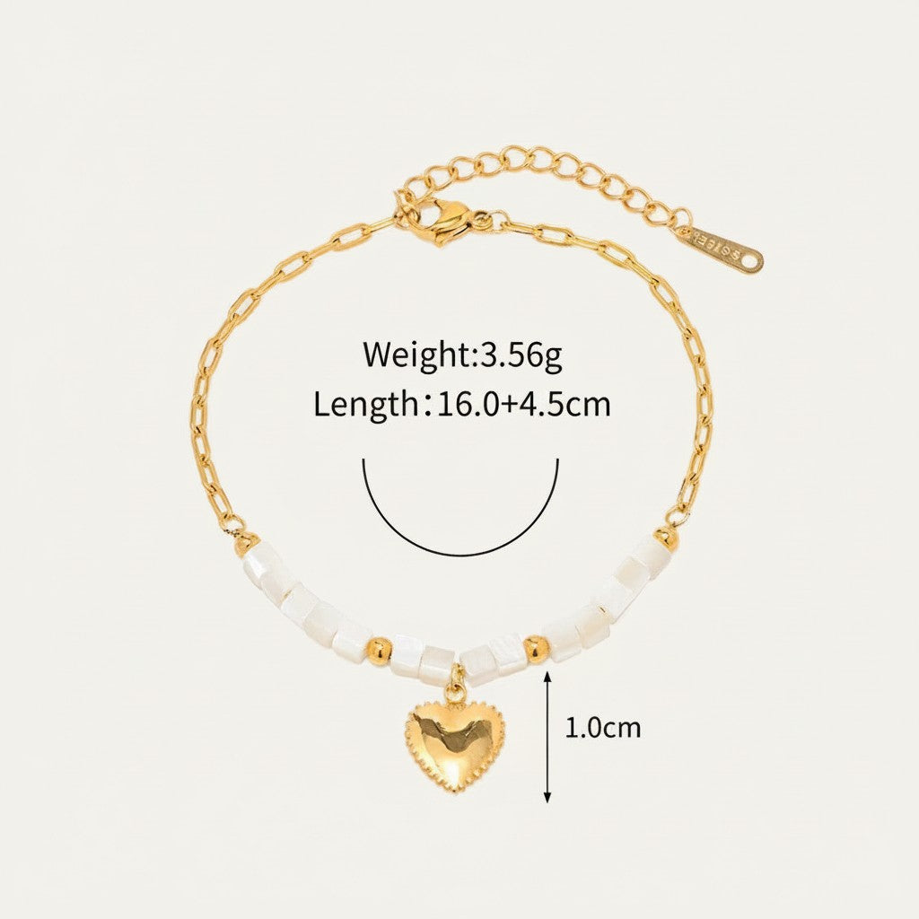 Seraphina Treasures Delia gold heart charm bracelet with white shell beads and gold accents.