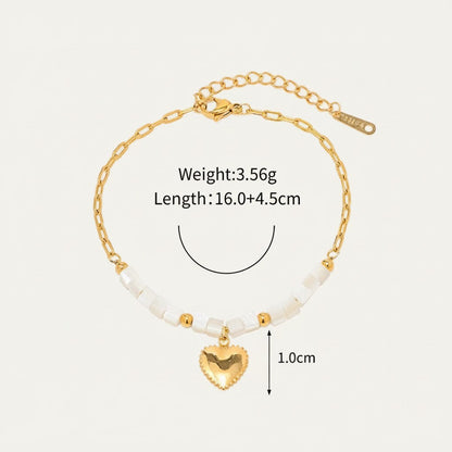 Seraphina Treasures Delia gold heart charm bracelet with white shell beads and gold accents.