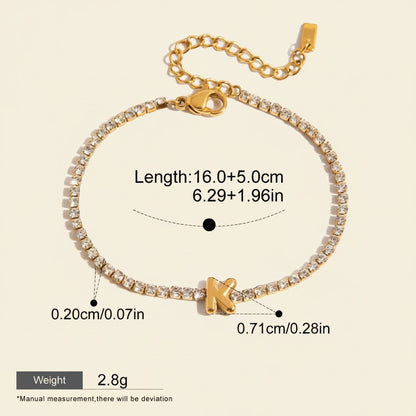 Seraphina Treasures gold-tone tennis bracelet with clear zirconia stones and a gold initial 'K' pendant. Adjustable chain.