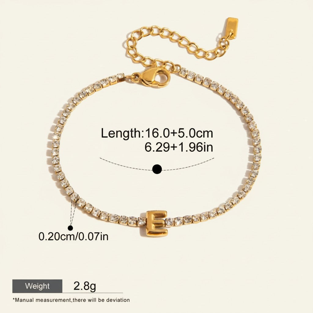 Seraphina Treasures gold-tone bracelet with clear zirconia stones and a gold initial 'E' pendant. Adjustable chain.