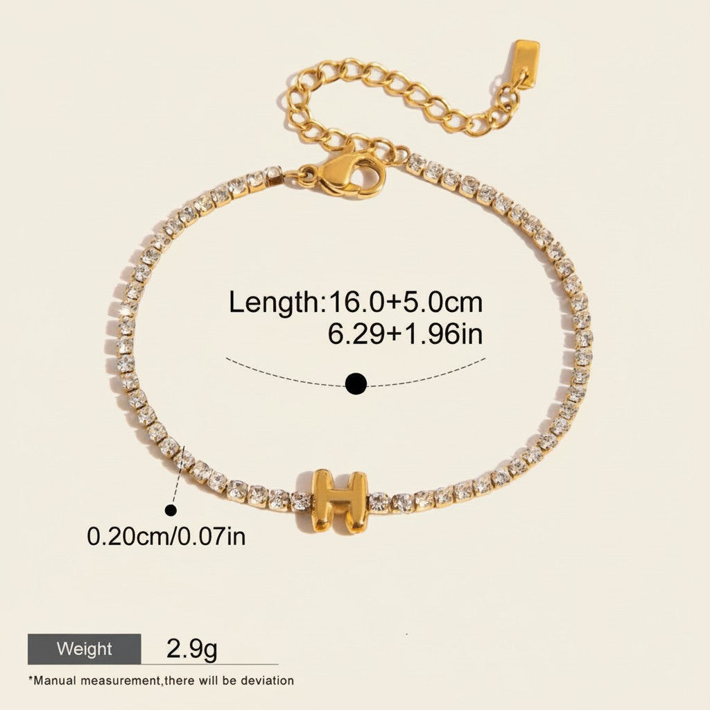 Seraphina Treasures gold-tone bracelet with clear zirconia stones and a gold initial 'H' pendant. Adjustable chain.