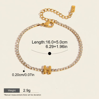 Seraphina Treasures gold-tone bracelet with clear zirconia stones and a gold initial 'H' pendant. Adjustable chain.