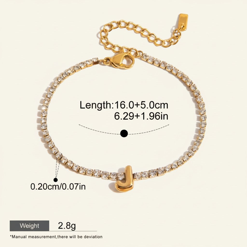 Seraphina Treasures gold-tone bracelet with clear zirconia stones and a gold initial 'J' pendant. Adjustable length.