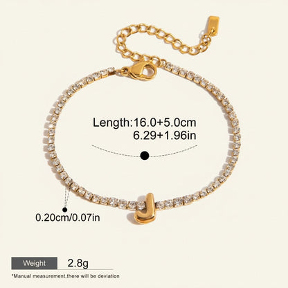 Seraphina Treasures gold-tone bracelet with clear zirconia stones and a gold initial 'J' pendant. Adjustable length.
