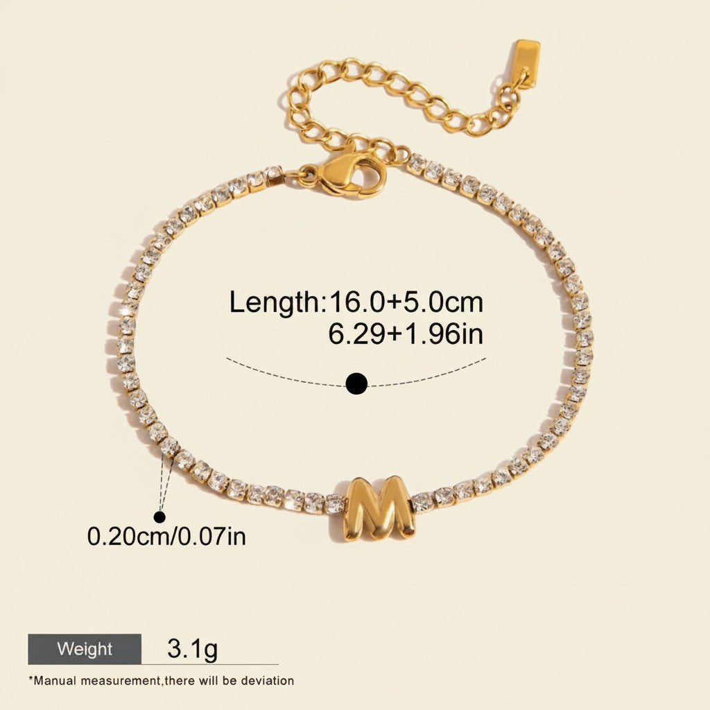 Seraphina Treasures gold-tone bracelet with clear zirconia stones and a gold initial 'M' pendant. Adjustable chain.