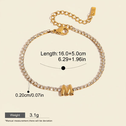 Seraphina Treasures gold-tone bracelet with clear zirconia stones and a gold initial 'M' pendant. Adjustable chain.