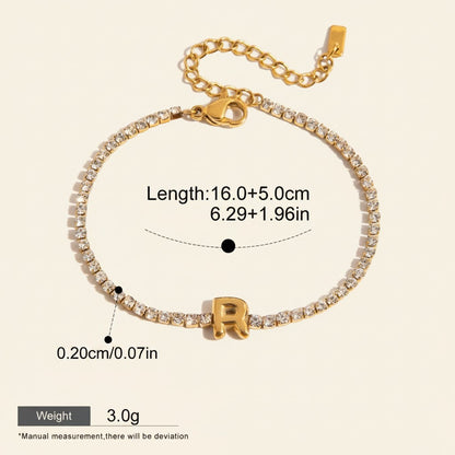 Seraphina Treasures gold-tone bracelet with clear zirconia stones and a gold initial 'R' pendant. Adjustable clasp closure.