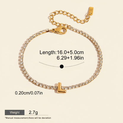 Seraphina Treasures gold-tone bracelet with clear zirconia stones and a gold letter 'L' pendant. Adjustable length.