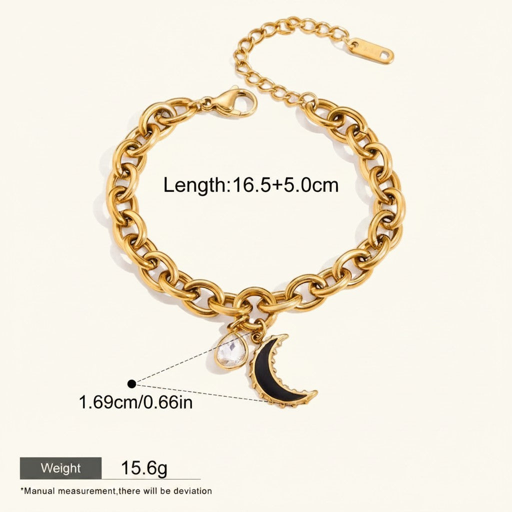 Seraphina Treasures gold chain bracelet with a clear zirconia water drop charm and a black crescent moon charm.