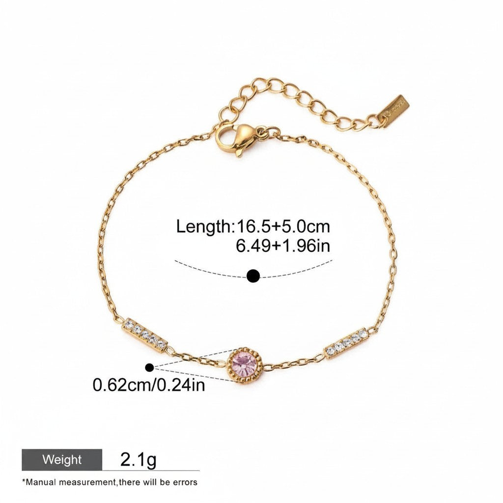 Seraphina Treasures gold-tone chain bracelet with a pink cubic zirconia center stone and clear cubic zirconia accents. Adjustable length.