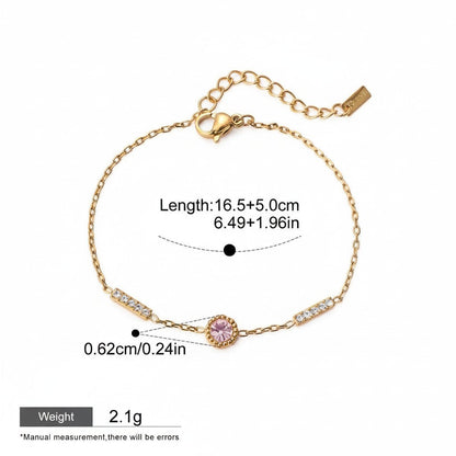 Seraphina Treasures gold-tone chain bracelet with a pink cubic zirconia center stone and clear cubic zirconia accents. Adjustable length.