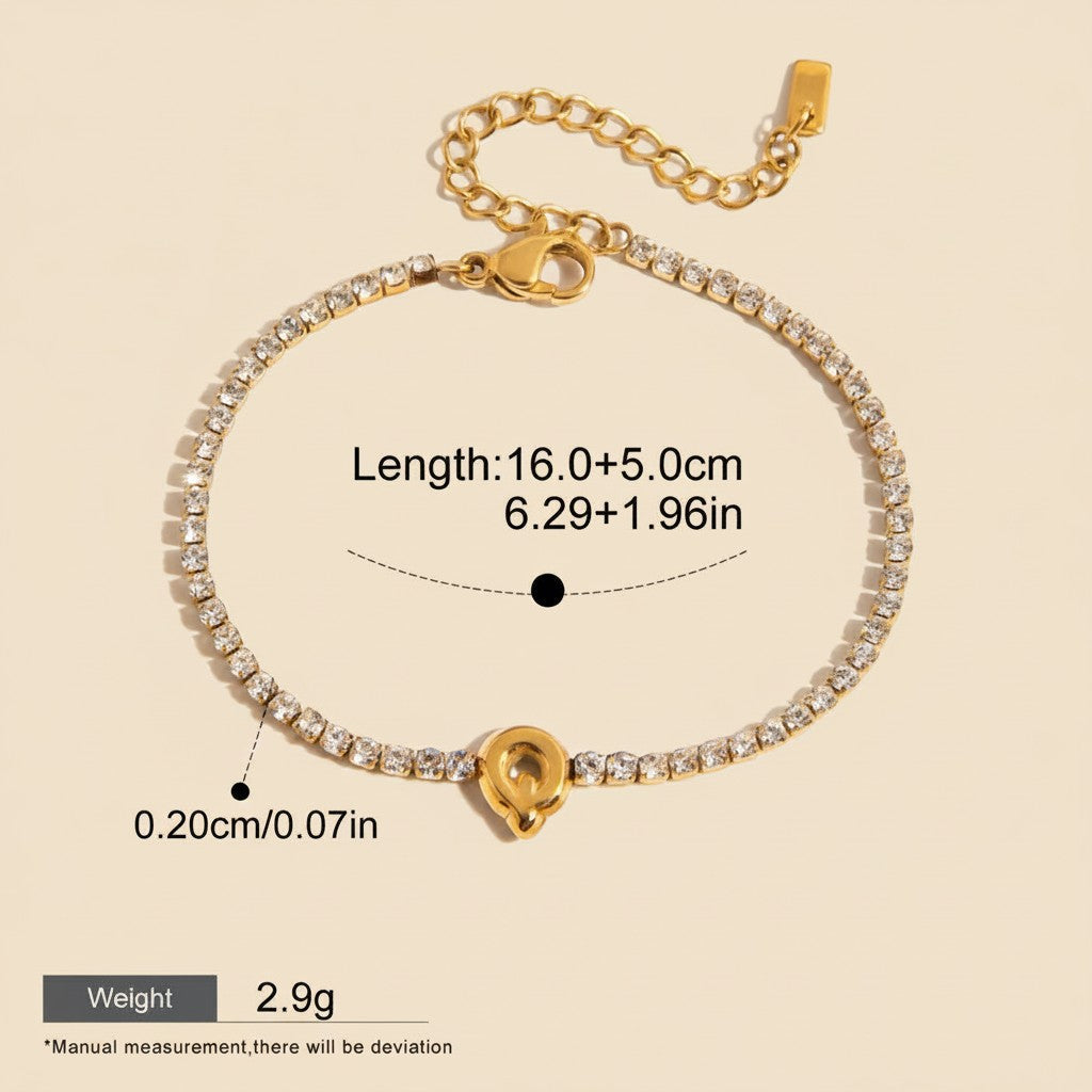 Seraphina Treasures gold-tone bracelet with clear cubic zirconia and a gold letter Q pendant. Adjustable length, waterproof, and hypoallergenic.