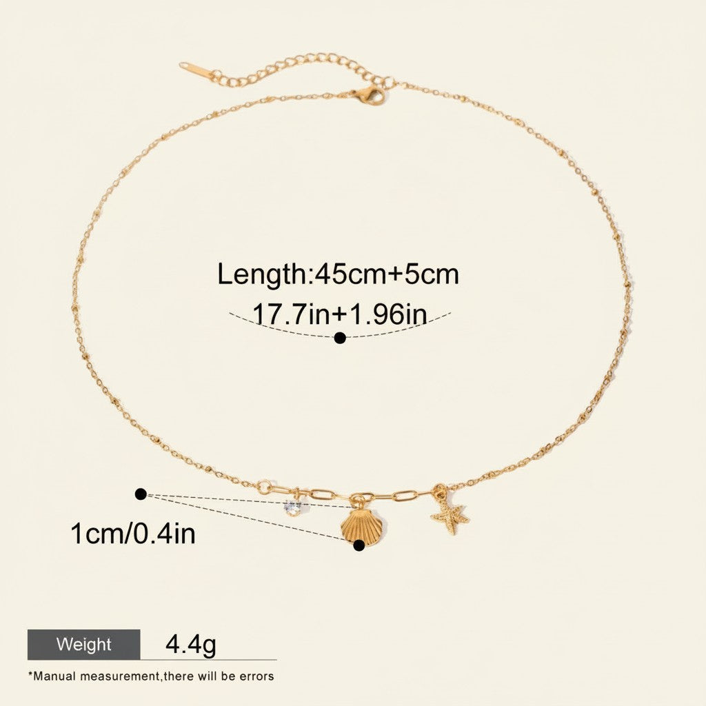 Seraphina Treasures gold necklace with shell and starfish charms, accented with white zircon. Adjustable length.