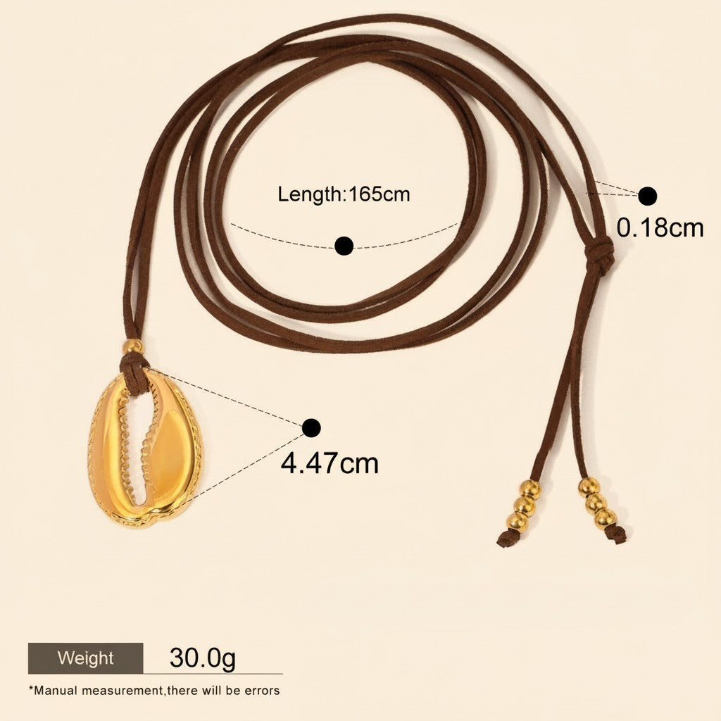 Seraphina Treasures gold cowrie shell pendant necklace on brown cord with gold bead accents.