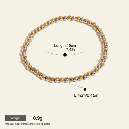 Seraphina Treasures Clio bracelet with alternating gold and silver stainless steel beads. Elastic design for a comfortable fit.