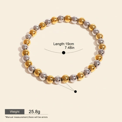Seraphina Treasures Clio bracelet with alternating gold and silver stainless steel beads. Elastic design for comfortable fit.