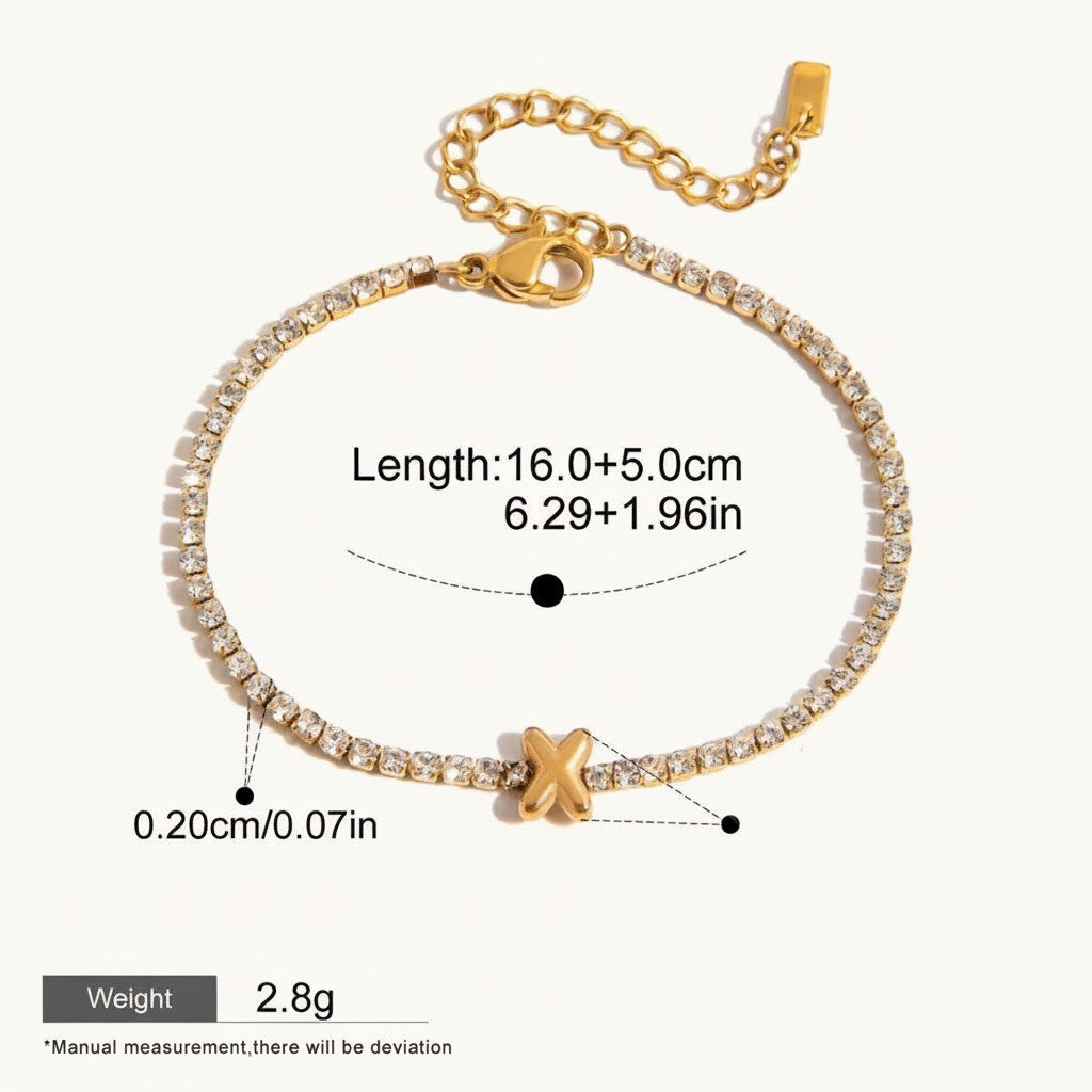 Seraphina Treasures gold-tone tennis bracelet with clear zirconia stones and a gold 'X' initial charm. Adjustable length, waterproof, and hypoallergenic.