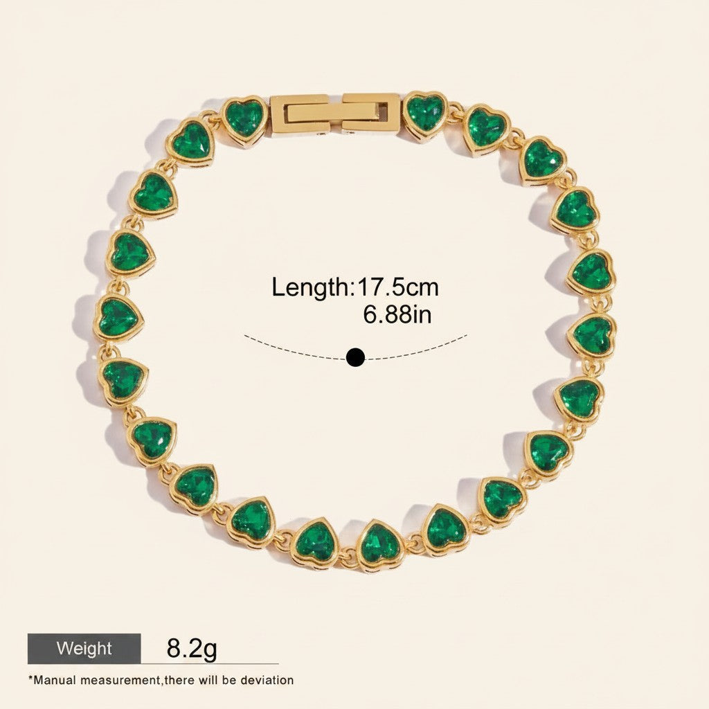 Seraphina Treasures gold-tone bracelet with green heart-shaped zirconia stones. Features a sleek chain and secure clasp. Waterproof and hypoallergenic.