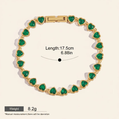 Seraphina Treasures gold-tone bracelet with green heart-shaped zirconia stones. Features a sleek chain and secure clasp. Waterproof and hypoallergenic.