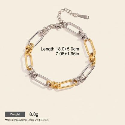 Seraphina Treasures Isolde two-tone link bracelet with cross clasp, silver and gold plated stainless steel.