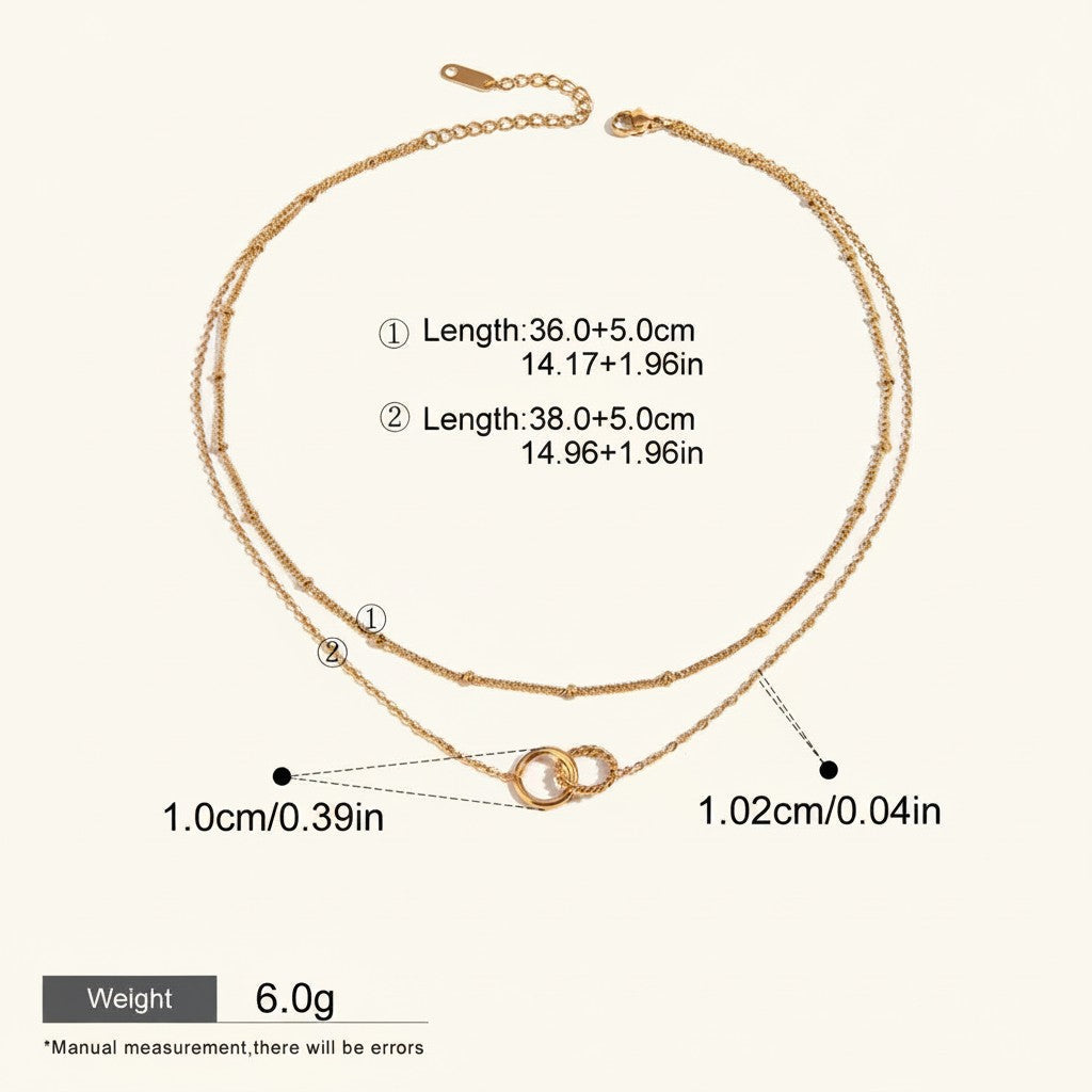 Seraphina Treasures Keeva gold-tone double chain necklace with interlocking rings pendant. Adjustable length.