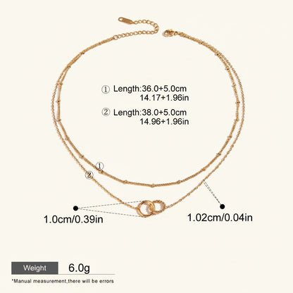 Seraphina Treasures Keeva gold-tone double chain necklace with interlocking rings pendant. Adjustable length.