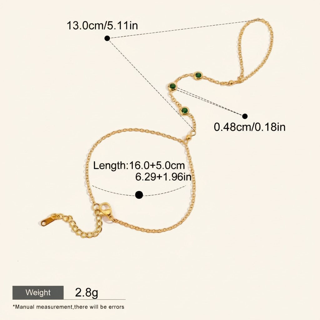 Seraphina Treasures Lyra gold-tone connected bracelet and ring set with green cubic zirconia stones.