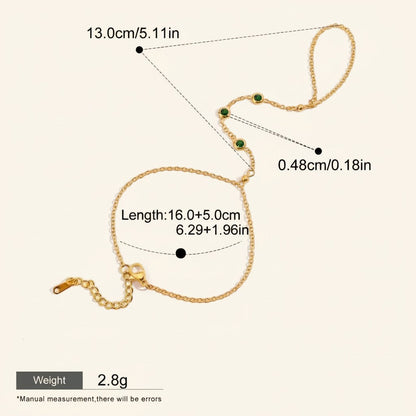 Seraphina Treasures Lyra gold-tone connected bracelet and ring set with green cubic zirconia stones.