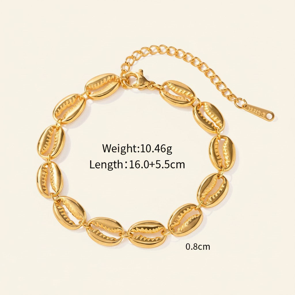 Seraphina Treasures Medea gold tone bracelet with shell charms and adjustable clasp. Lightweight and elegant for everyday or special occasions.