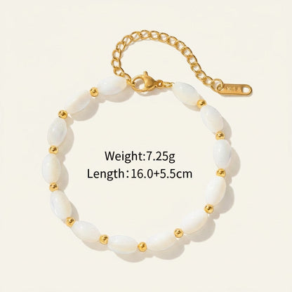 Seraphina Treasures Delia bracelet with oval white shell beads and gold accents, adjustable gold chain.