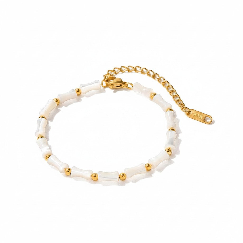 Seraphina Treasures Delia bracelet with white shell beads and gold accents, adjustable length.