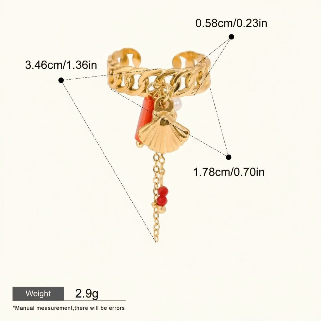 Seraphina Treasures gold-tone ring with shell and coral charms, pearl accent, and red bead chain. Adjustable cuff style.