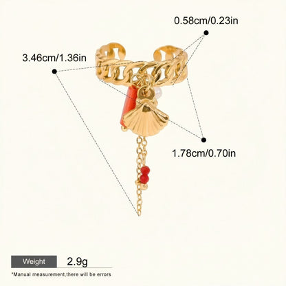 Seraphina Treasures gold-tone ring with shell and coral charms, pearl accent, and red bead chain. Adjustable cuff style.