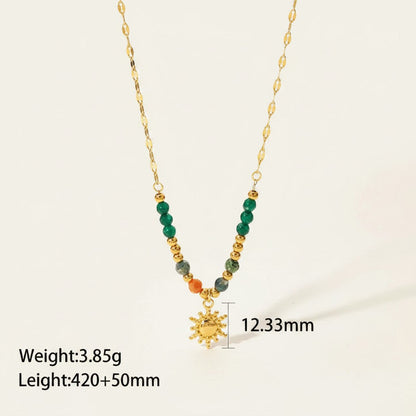 Seraphina Treasures gold sun pendant necklace with green and orange natural stone beads.
